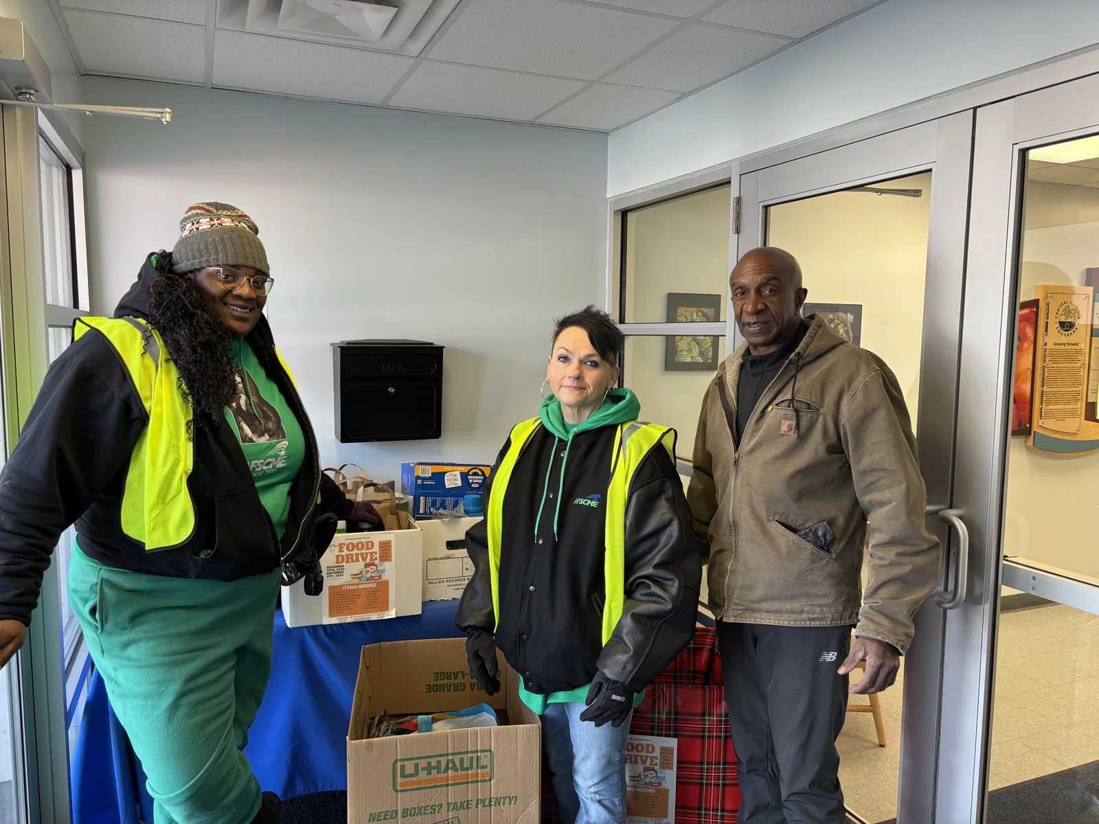 People standing beside boxes of collected food