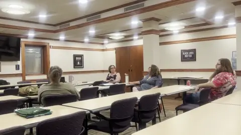 People talking around meeting tables