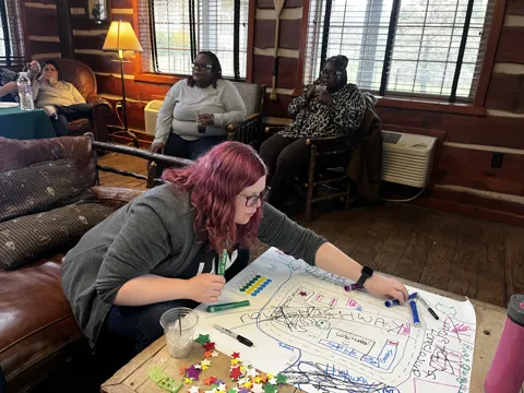 A participant adds to a shared tabletop activity.