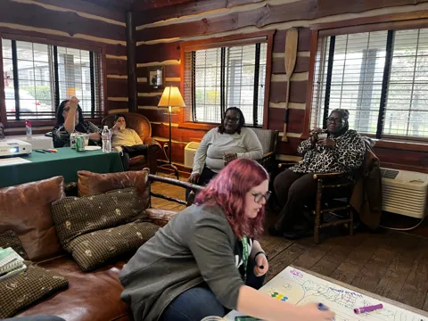 Another view of the tabletop activity and seated participants.