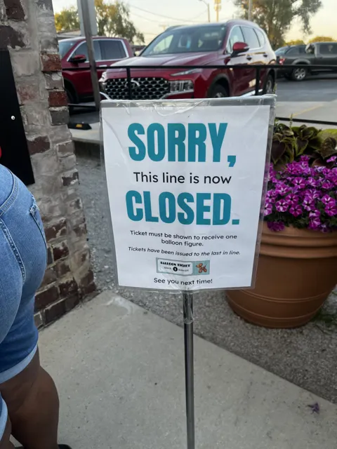 A sign reads “Sorry, this line is now closed.”