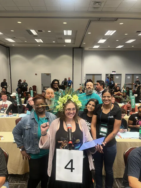 A group poses at a table marked with the number four.