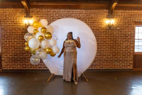 Another guest poses beside the balloon display.