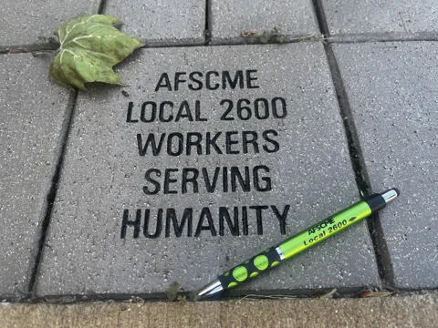 Another view of the engraved stone and pen.
