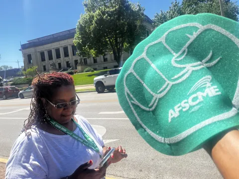A participant with an AFSCME symbol near the Capitol grounds.