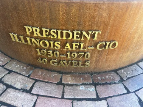 A monument inscription reads “President Illinois AFL–CIO 1930–1970 40 gavels.”
